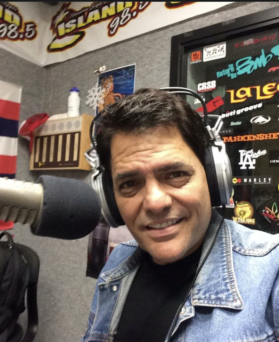 Junior Kekuewa Jr. wearing headphones in a Hawaii radio studio