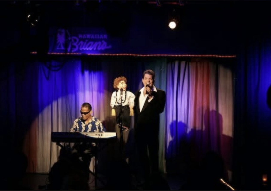 Junior Kekuewa Jr. performing on stage with Wayne Borje at the keyboard